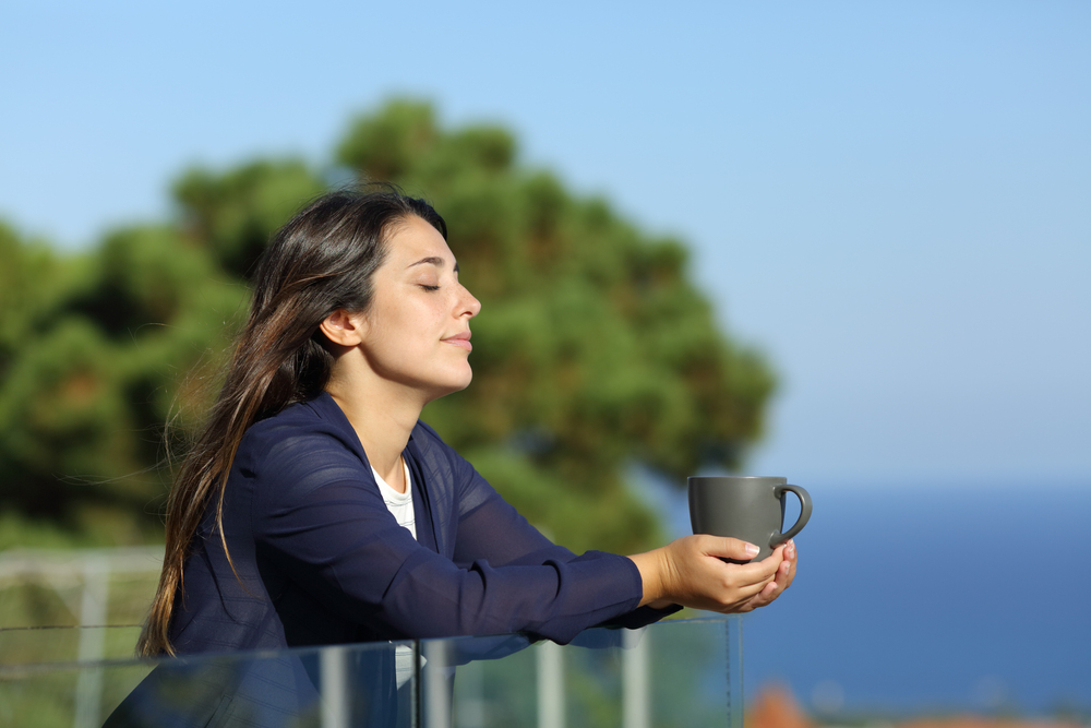 Relaxed,Woman,With,Closed,Eyes,Holding,Coffee,Mug,In,A